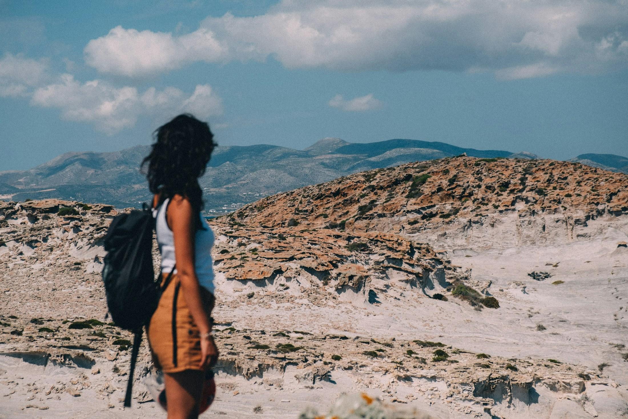 Traveler on rocky coastline